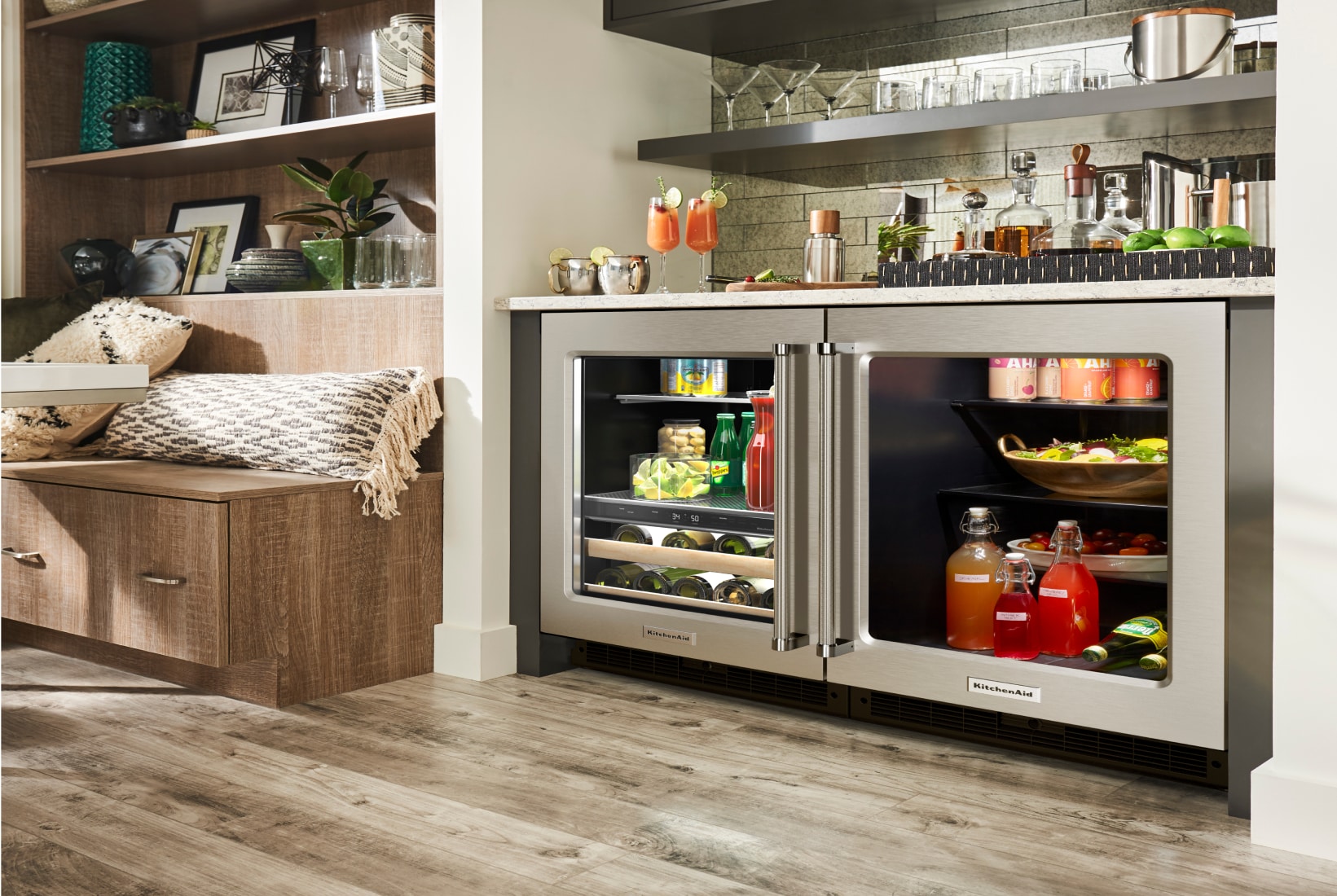 A pair of KitchenAid® undercounter refrigerators installed into a wet bar area.