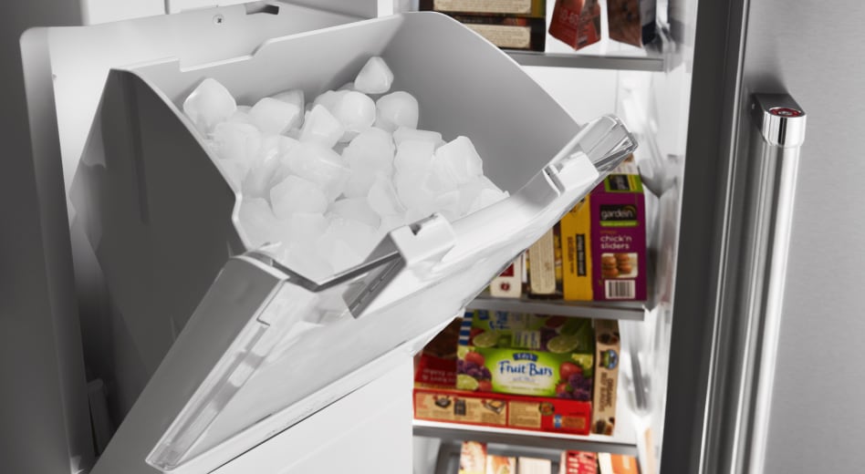 Refrigerator ice dispenser storage bucket filled with ice Refrigerator ice dispenser storage bucket filled with ice