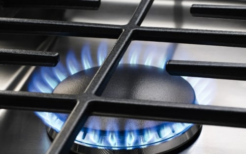 Close up image of a gas stovetop burner 