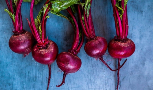 Clean beetroots resting on a table.