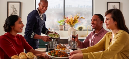 Friends gathered around a table eating a meal