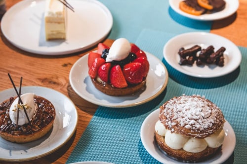 Small, decadent pastries resting on white plates.